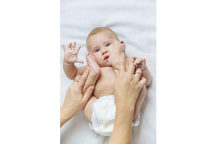 Mother massage baby on the bed, a Person Photo by yanadjana