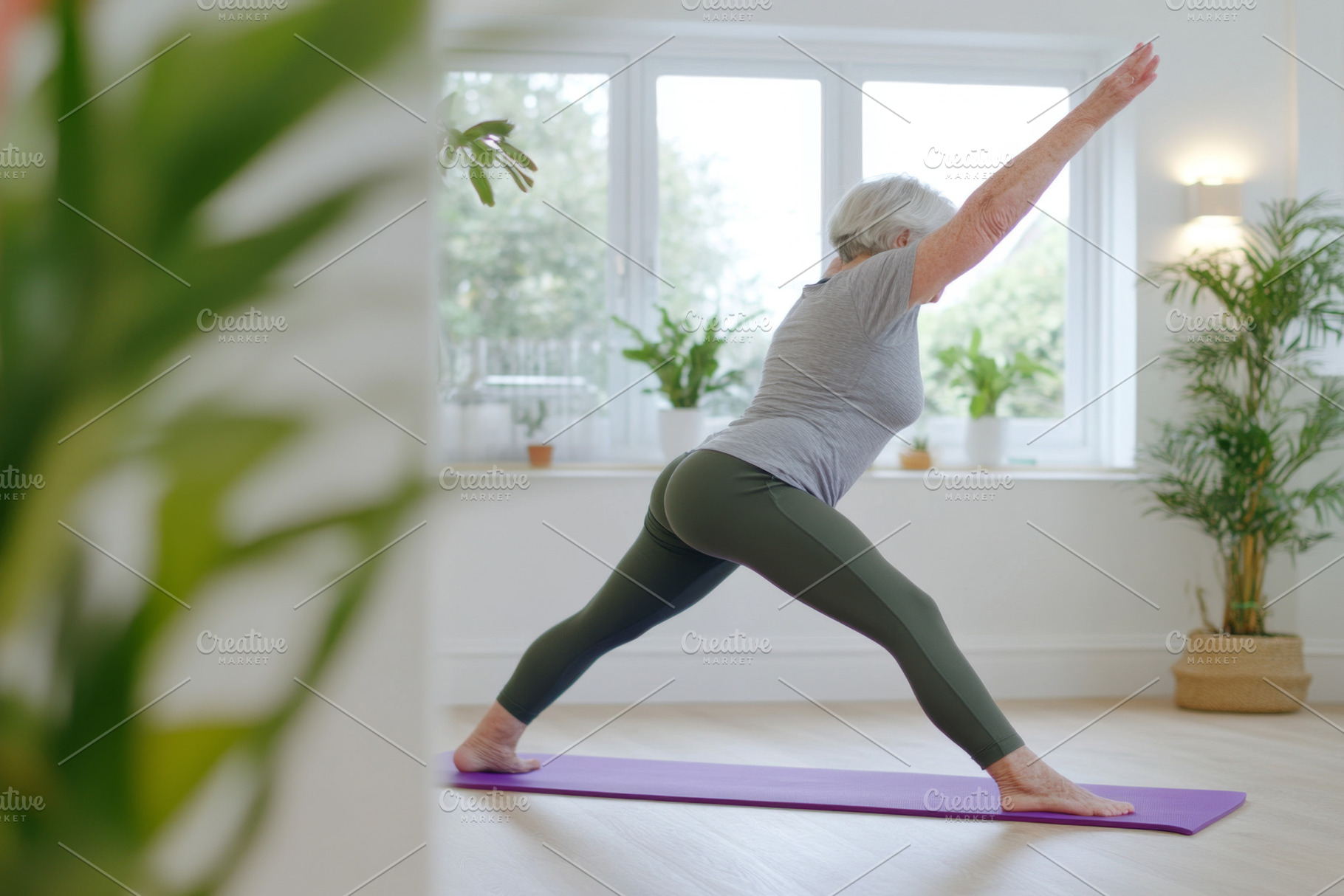 Elderly woman doing leg exercise in, a Photo by Dvoevnore photos