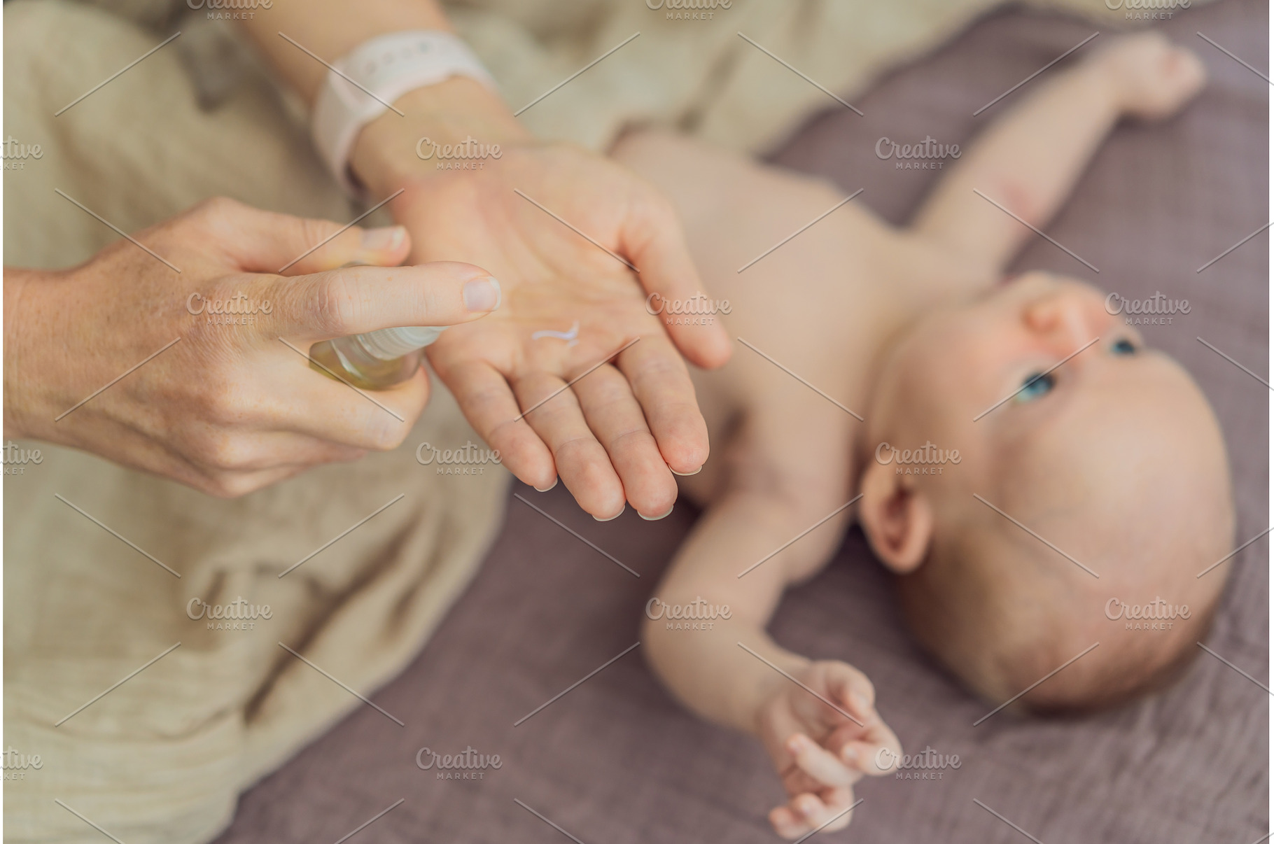 A mother gently massages her 1-month, a Person Photo by Elizaveta Galitskaya