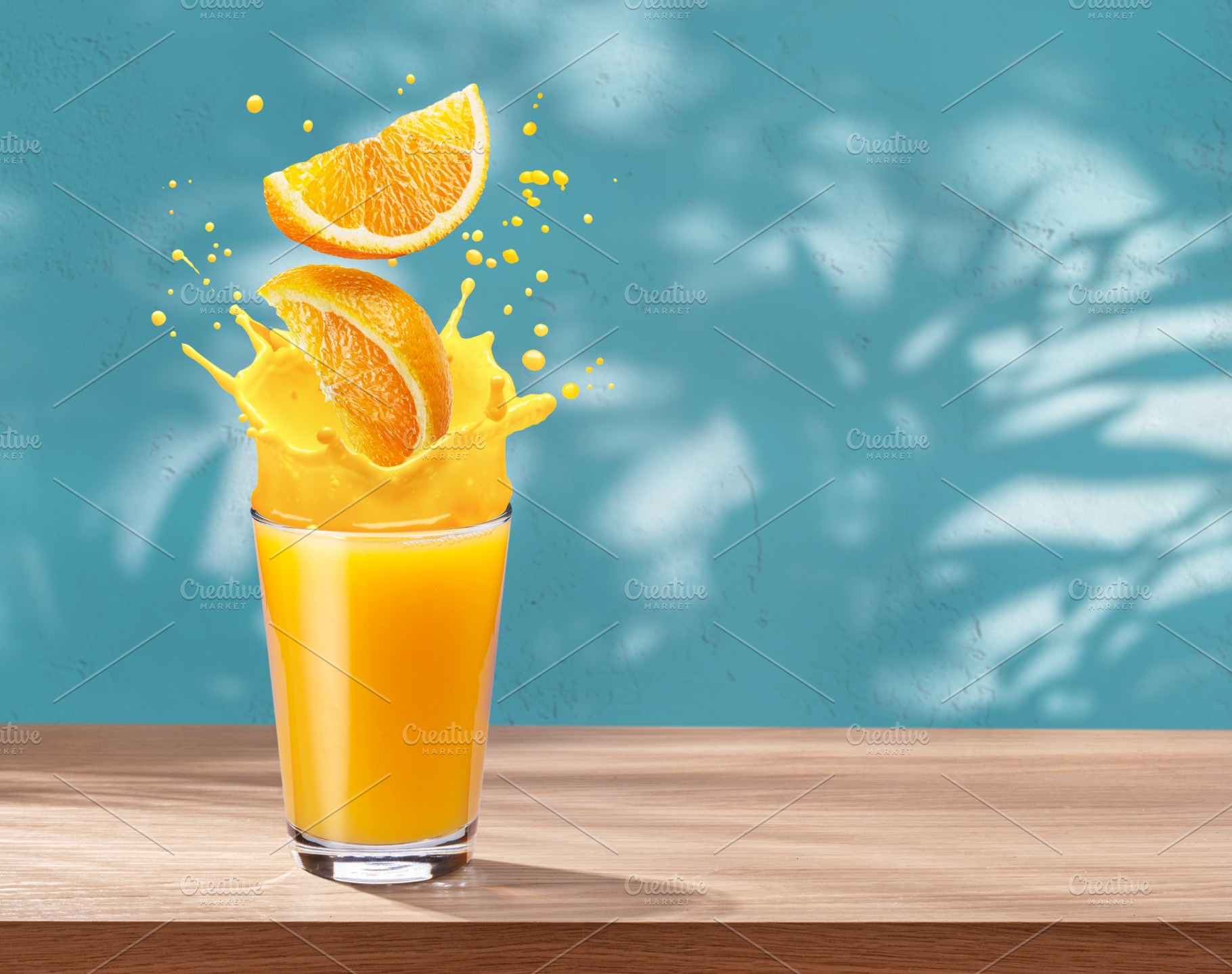 Glass of orange juice with orange splash on the table and stucco, a Food & Drink Photo by Volff