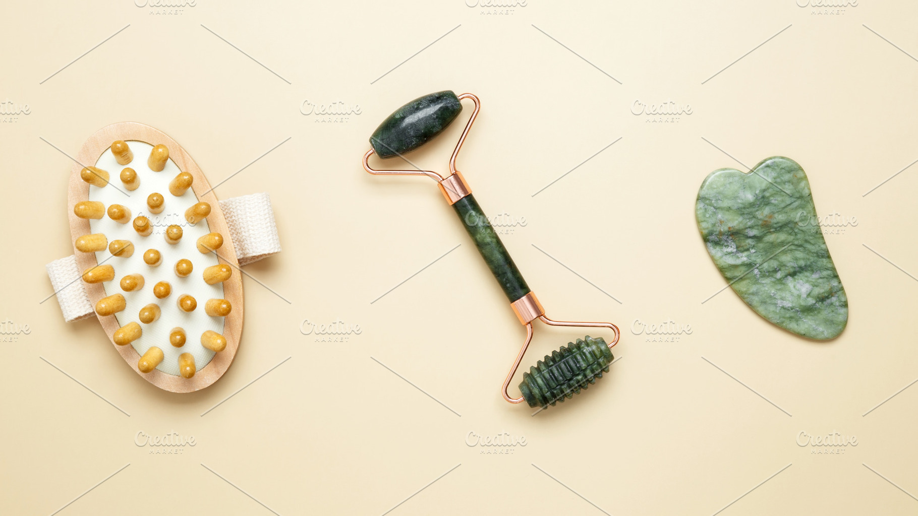 Skincare tools including marble roller, gua sha, and wooden brush arranged for, a Photo by matucha