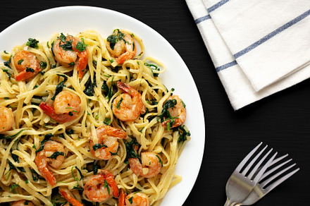 Homemade One-Pot Lemon Garlic Shrimp Pasta on a Plate on a black, a Food & Drink Photo by LiudmylaChuhunova