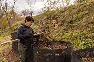 Woman composting organic waste, a Photo by Grafvision photography