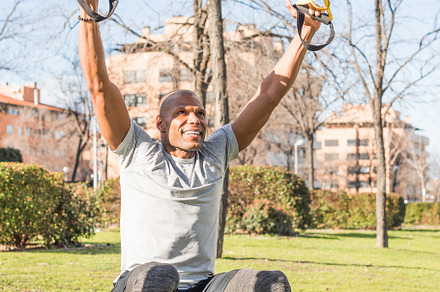 Athlete exercising with trx fitness straps in the park, a Sports & Recreation Photo by Iván Moreno STOCK PHOTO