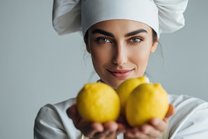 Chef holds fresh lemons in kitchen, a Photo by Beautiful things