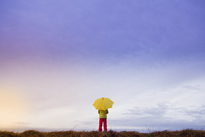 person with umbrella on rainy day
