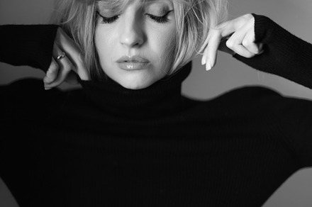 Close up portrait of a woman with pink hair and a black sweater on background i, a Person Photo by SaulichPhoto