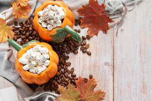 Pumpkin mugs with marshmallows, coffee beans, autumn leaves, a Food & Drink Photo by Olena Rudo