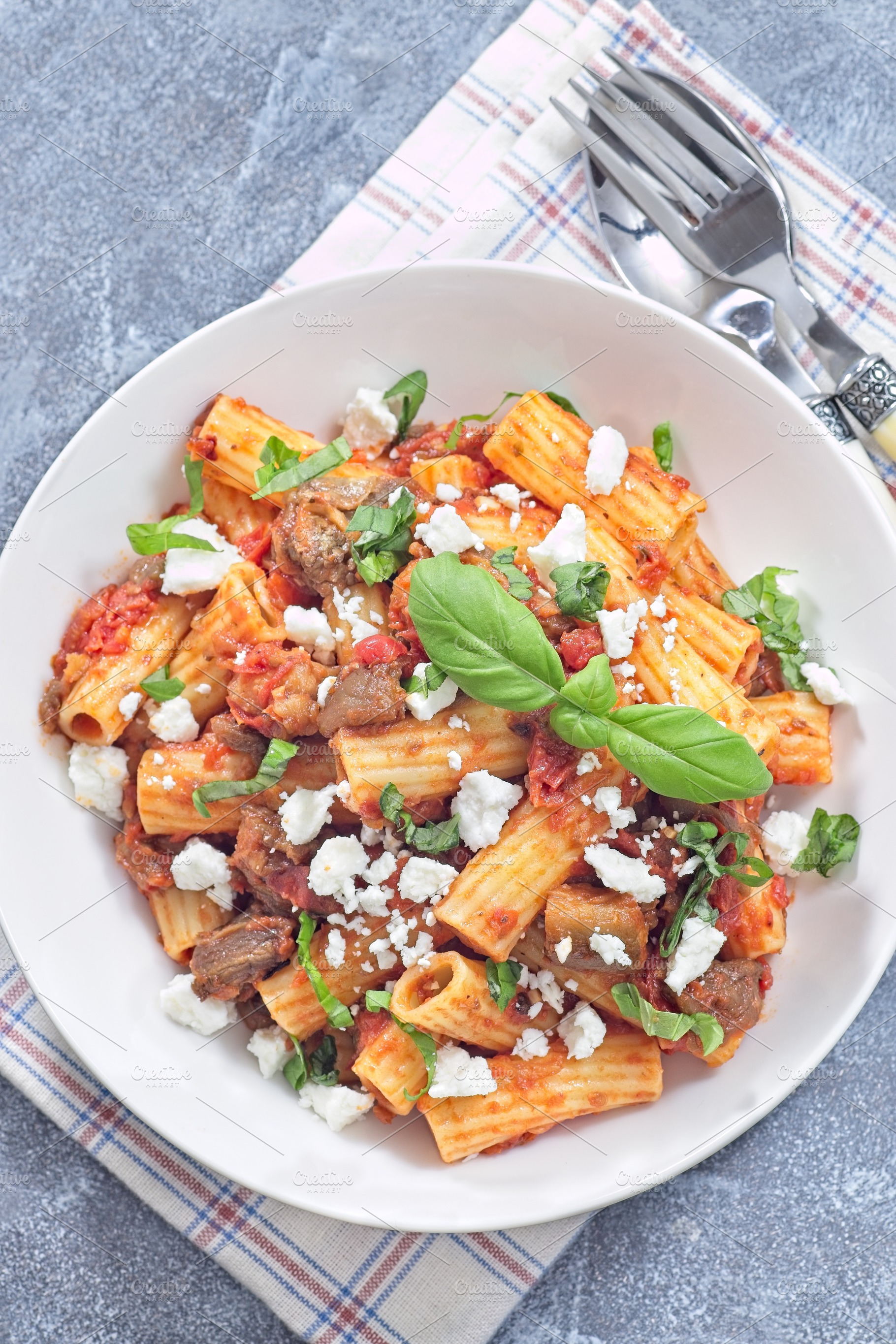 Rigatoni alla Norma pasta with eggplant, tomato, basil and ricotta salata, hori, a Food & Drink Photo by iuliia_n