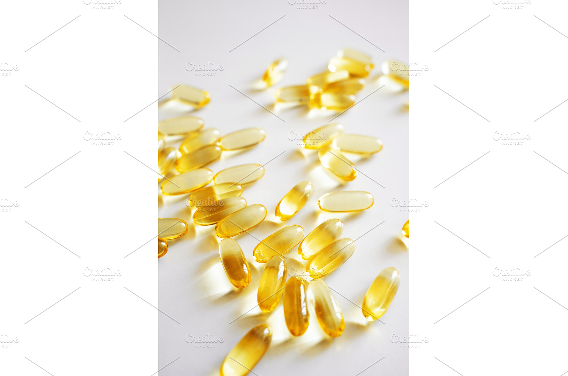 Fish oil omega capsules scattered on, a Health & Medical Photo by volodymyrshtun13795