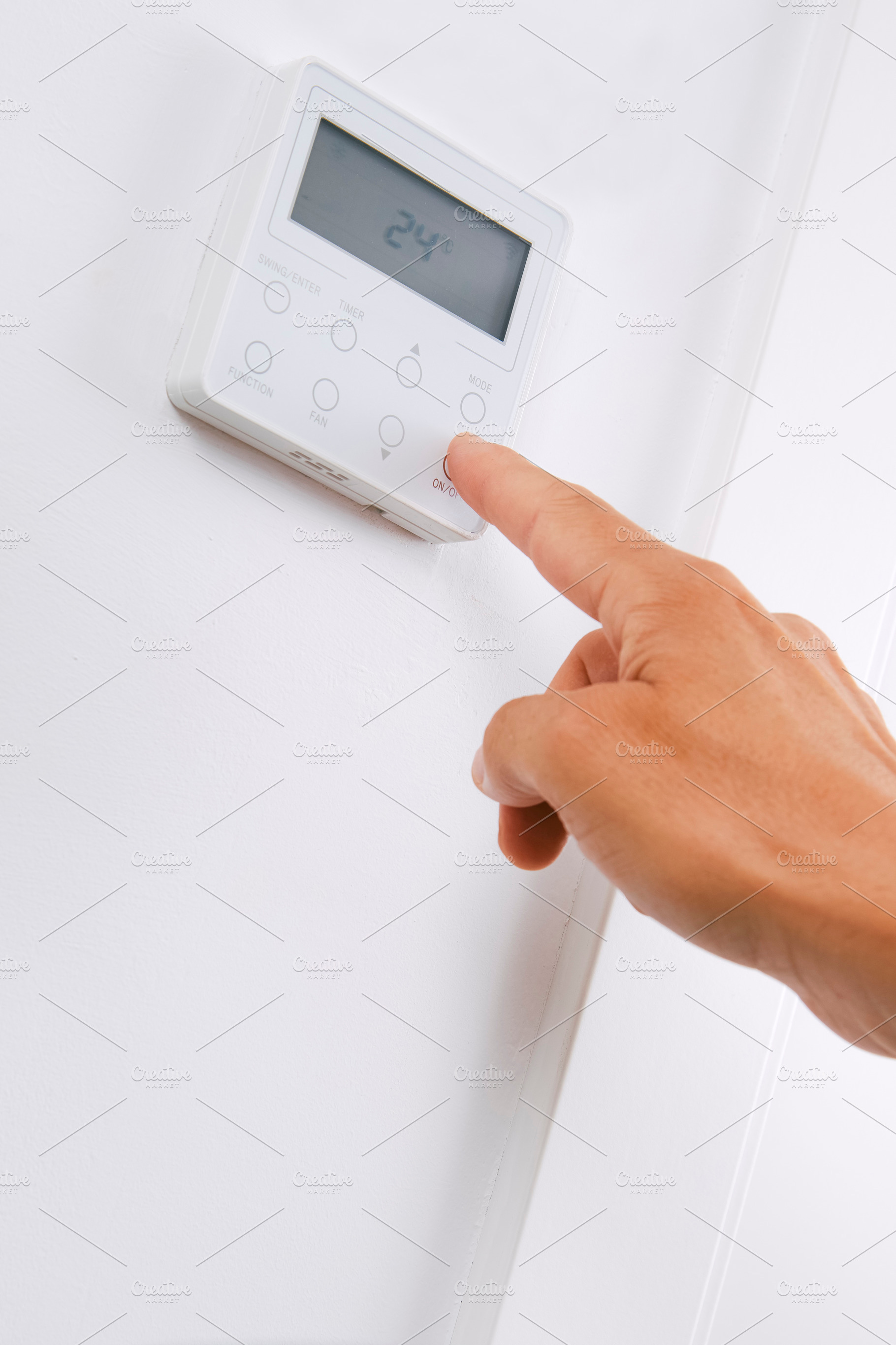 a man turns on or off the air conditioner, a Photo by Nito