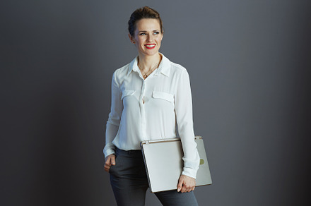 smiling elegant business owner woman isolated on grey, a Business Photo by Alliance Images