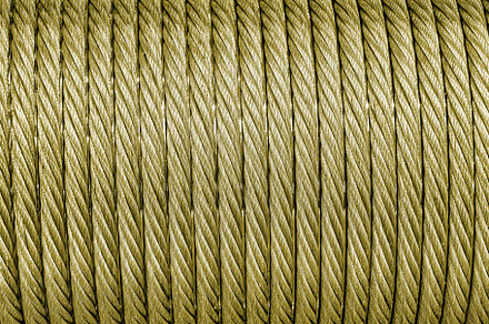 The texture of a new golden color cable wrapped in a spool. Abst, an Abstract Photo by Eugene_Photo