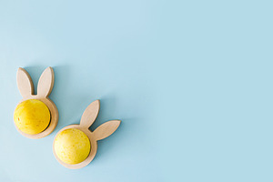 Easter flat lay. Stylish easter egg in wooden bunny ears holder, a Holiday Photo by Sonjachni