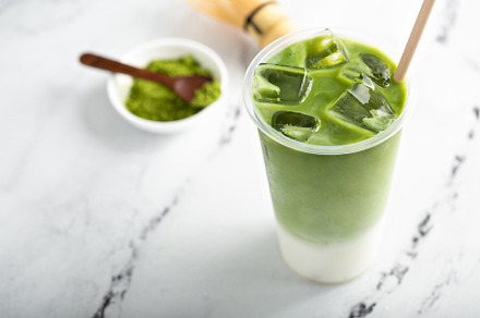 Cold matcha latte in a tall glass on marble, a Food & Drink Photo by farwasser