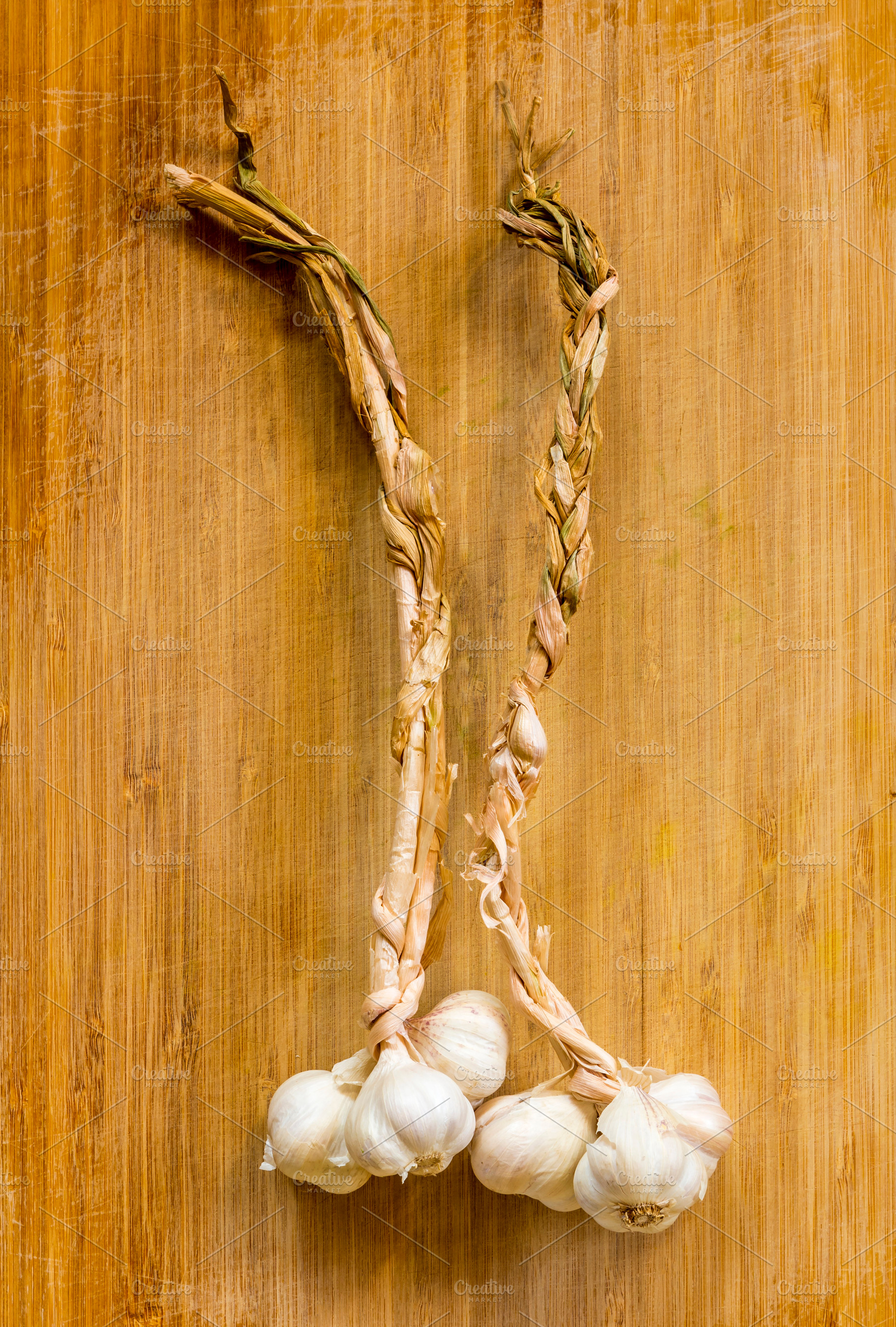 Garlic Braids On Wooden Board, a Food & Drink Photo by THP Creative