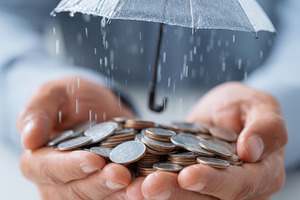 Financial protection concept with coins and umbrella, a Business Photo by AlyaAnd