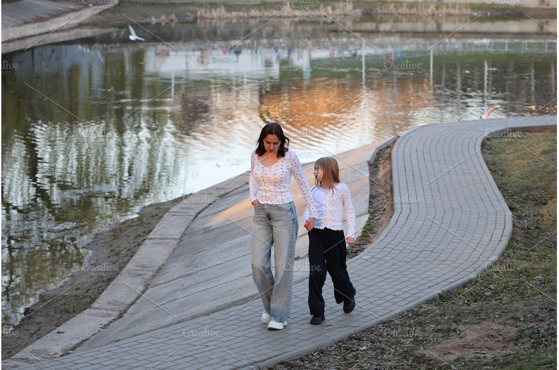 A mother and daughter are walking, a Person Photo by Nenahliadava Design
