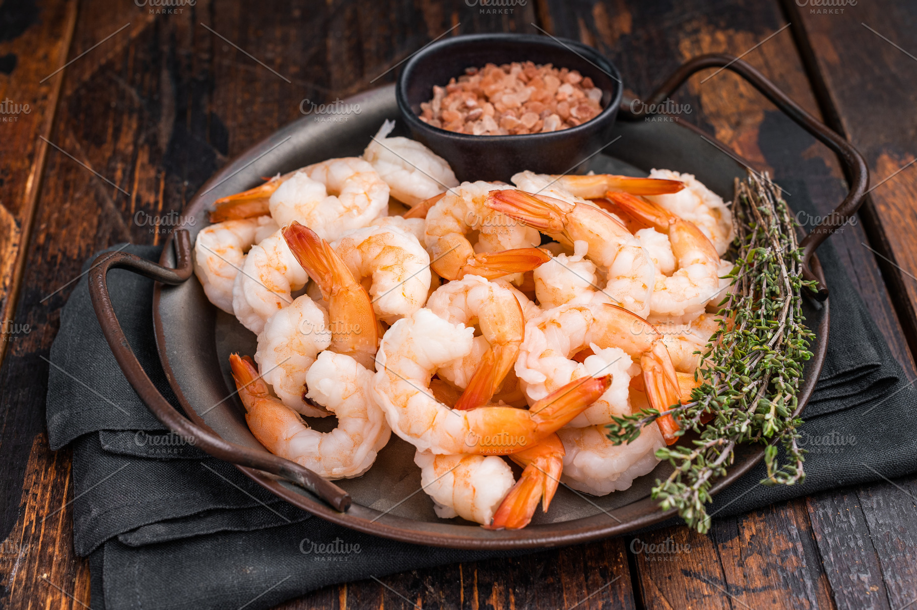 A plate of shrimp with a black bowl of salt and pepper. The shri, a Food & Drink Photo by composter-box@mail.ru
