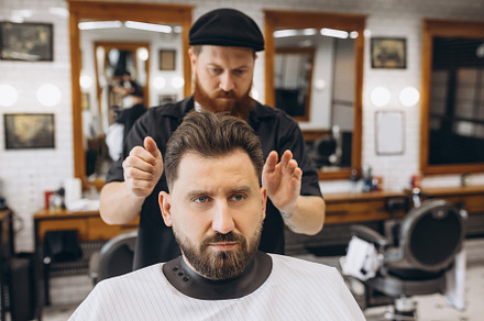 Man getting haircut at the barbershop. Professional barber at work process. Bea, a Person Photo by Volodymyr Melnyk