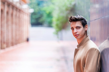 Portrait of stylish handsome young man with coat standing outdoo, a Person Photo by RF Images