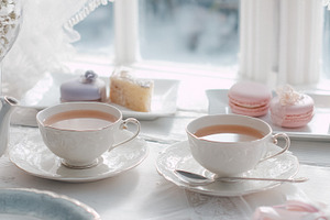 Elegant tea party setting with hot tea in delicate cups and vari, a Photo by Studio ANNA