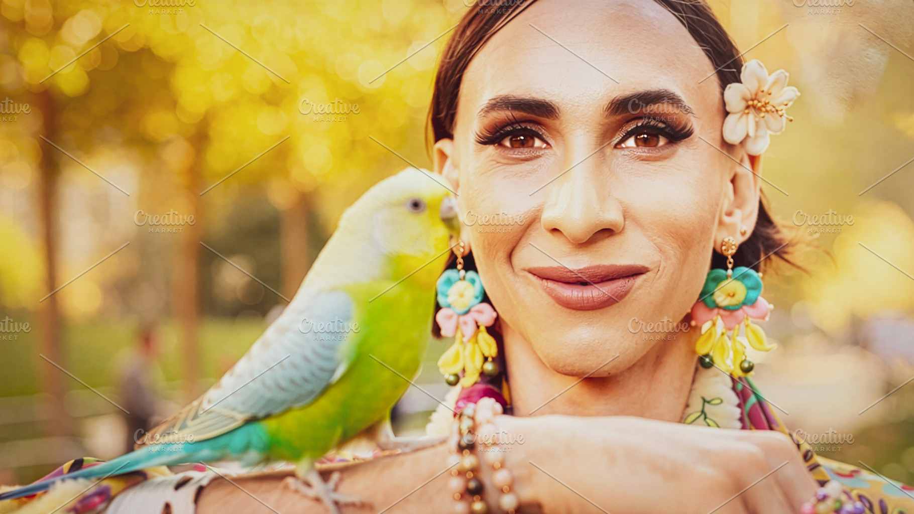Trans woman with budgerigar at urban park, a Person Photo by DanFLCreativo