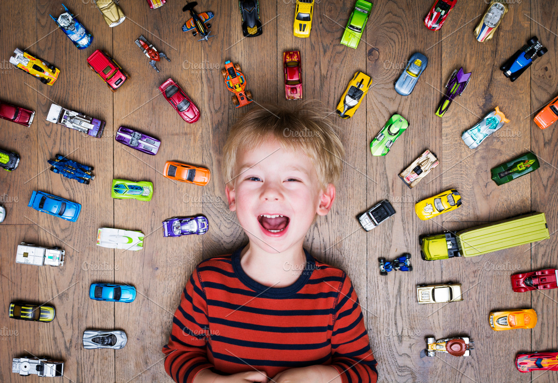 Boy with toy cars containing cheerful, car, and kid, a Person Photo by Twin Design
