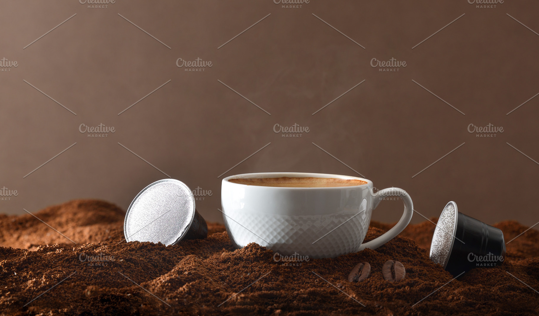Espresso cup on ground coffee with capsules around front view, a Food & Drink Photo by Davizro's Market