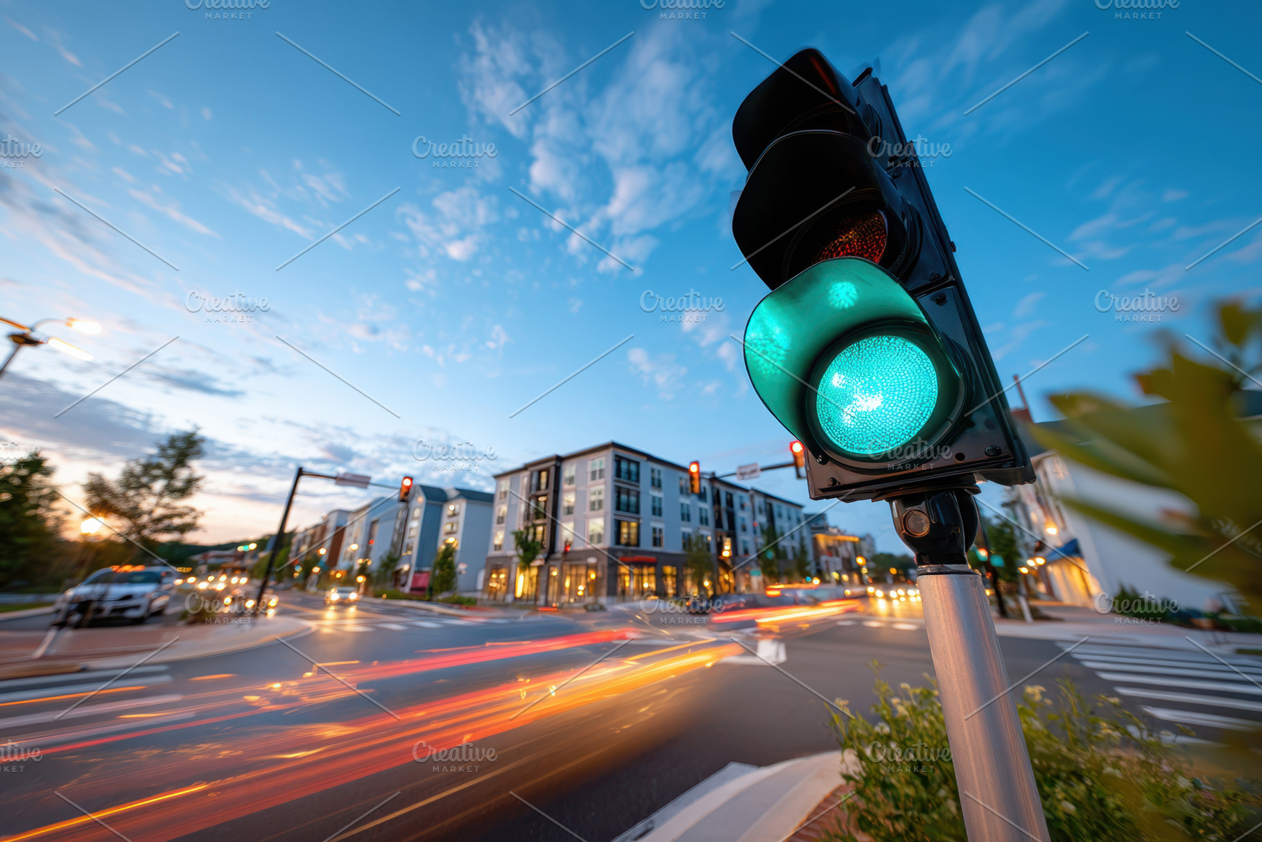 Green traffic light on busy city street at dusk, a Transportation Photo by AlyaAnd