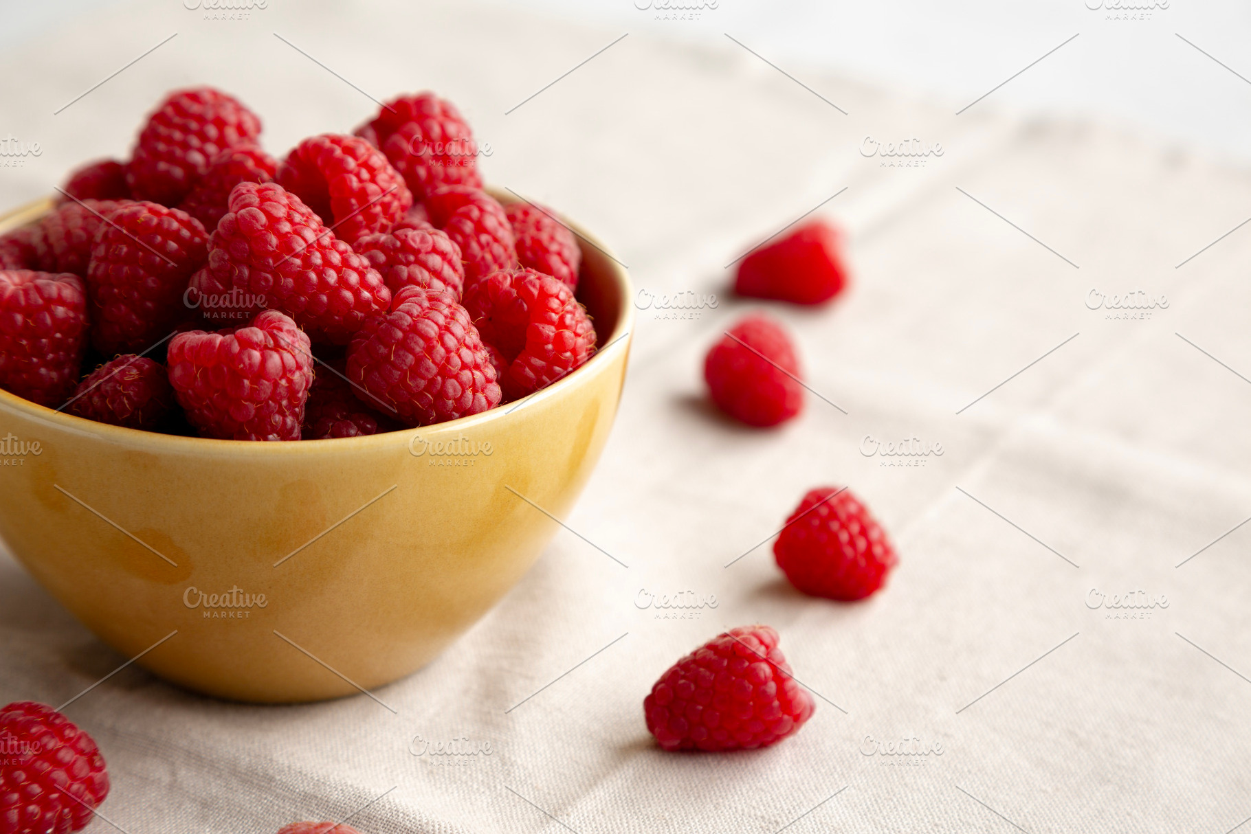 Organic Raw Red Raspberries in a Bowl, side view. Copy space., a Food & Drink Photo by LiudmylaChuhunova