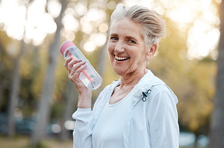 Exercise, senior woman and water bottle for fitness, workout in nature or portrait. Mature female, elderly lady and hydration for wellness, health and training outdoor for cardio, retirement or relax, a Photo by Peopleimages.com
