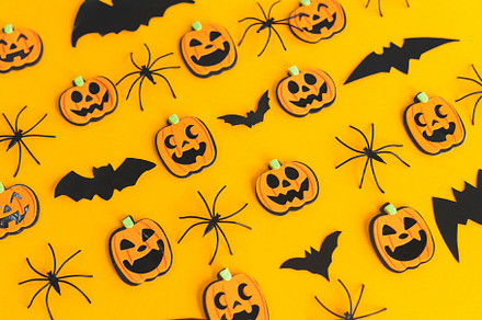 Happy Halloween. Pumpkins, spiders, bats flat lay on orange back, a Holiday Photo by Sonjachni