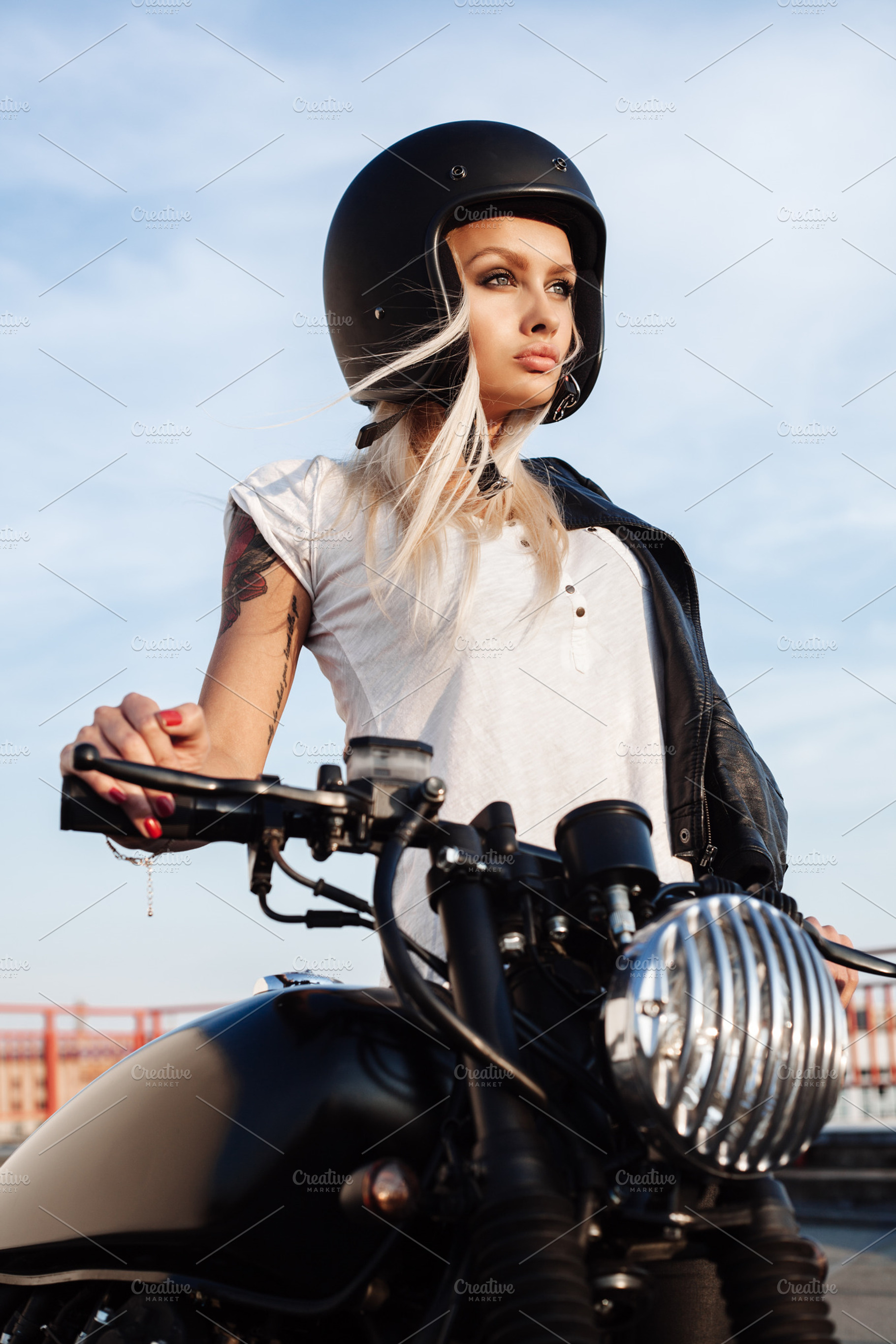Fashion female biker girl with vintage custom motorcycle stock photo, a Person Photo by Aliaksei Kaponia