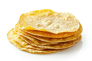 Stack of corn tortillas isolated on white background, a Food & Drink Photo by AlyaAnd