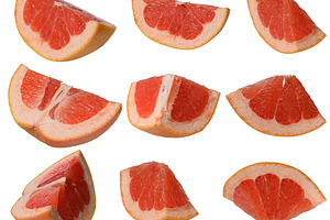 Several sliced red grapefruit wedges, arranged on isolated, a Food & Drink Photo by ndanko