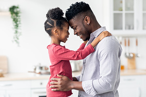 Emotional photo of loving black father and daughter cuddling, a Photo by Prostock-Studio