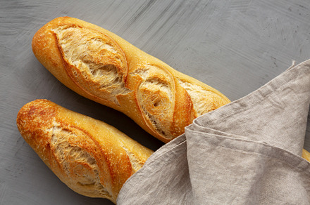 Homemade French Bread Baguette on a gray background, top view., a Food & Drink Photo by LiudmylaChuhunova