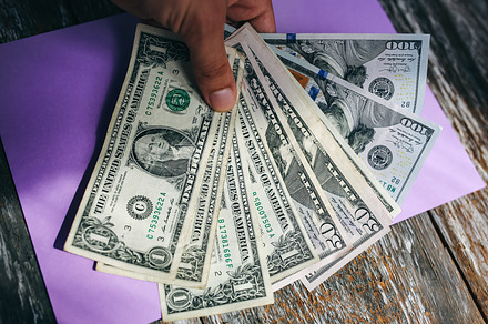 Man is holding dollar banknotes 