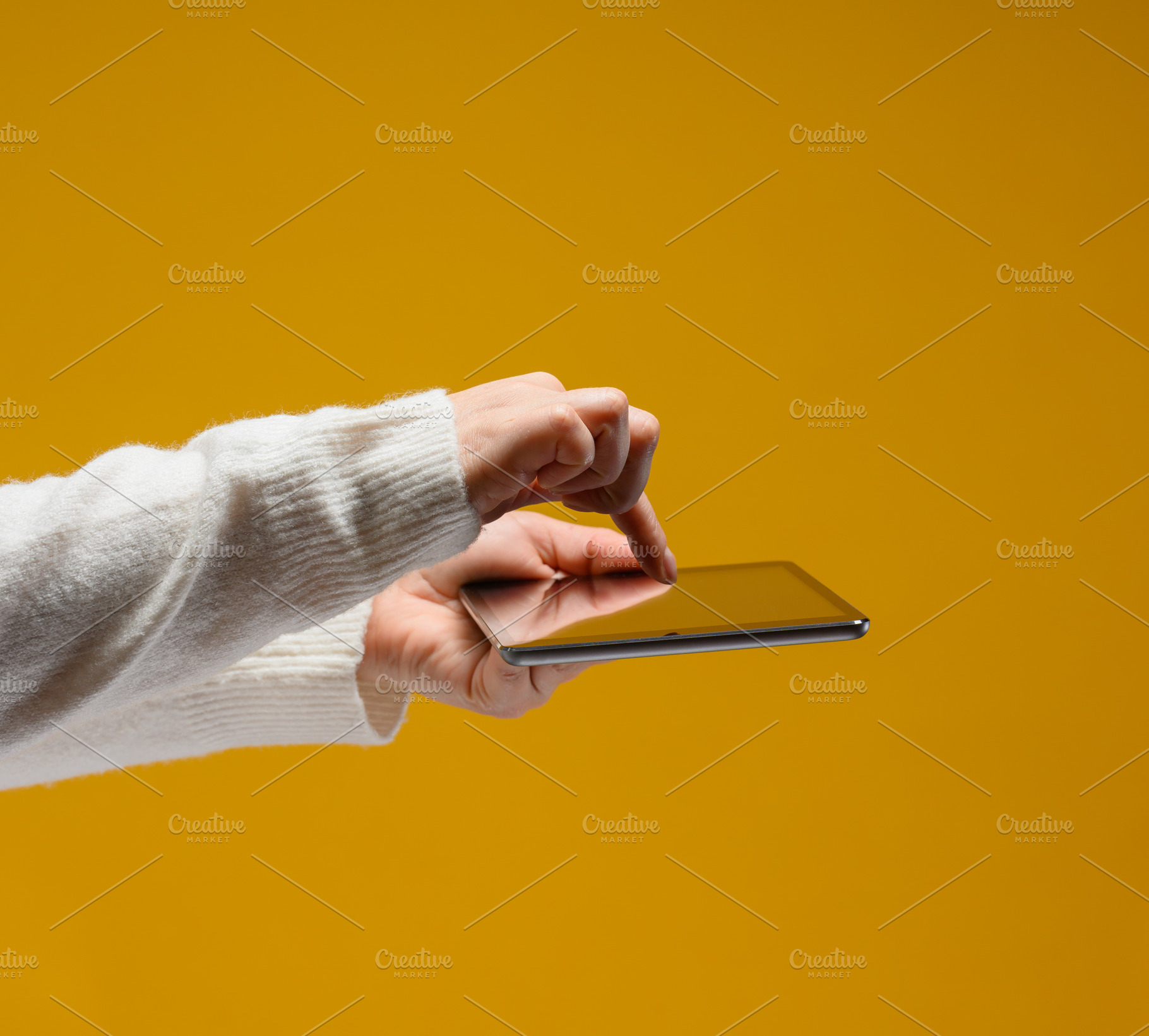 Female hands in a white sweater hold an electronic tablet horizo, a Technology Photo by ndanko