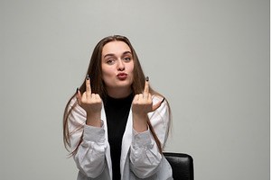 Woman showing rude middle finger, a Person Photo by volodymyrshtun13795
