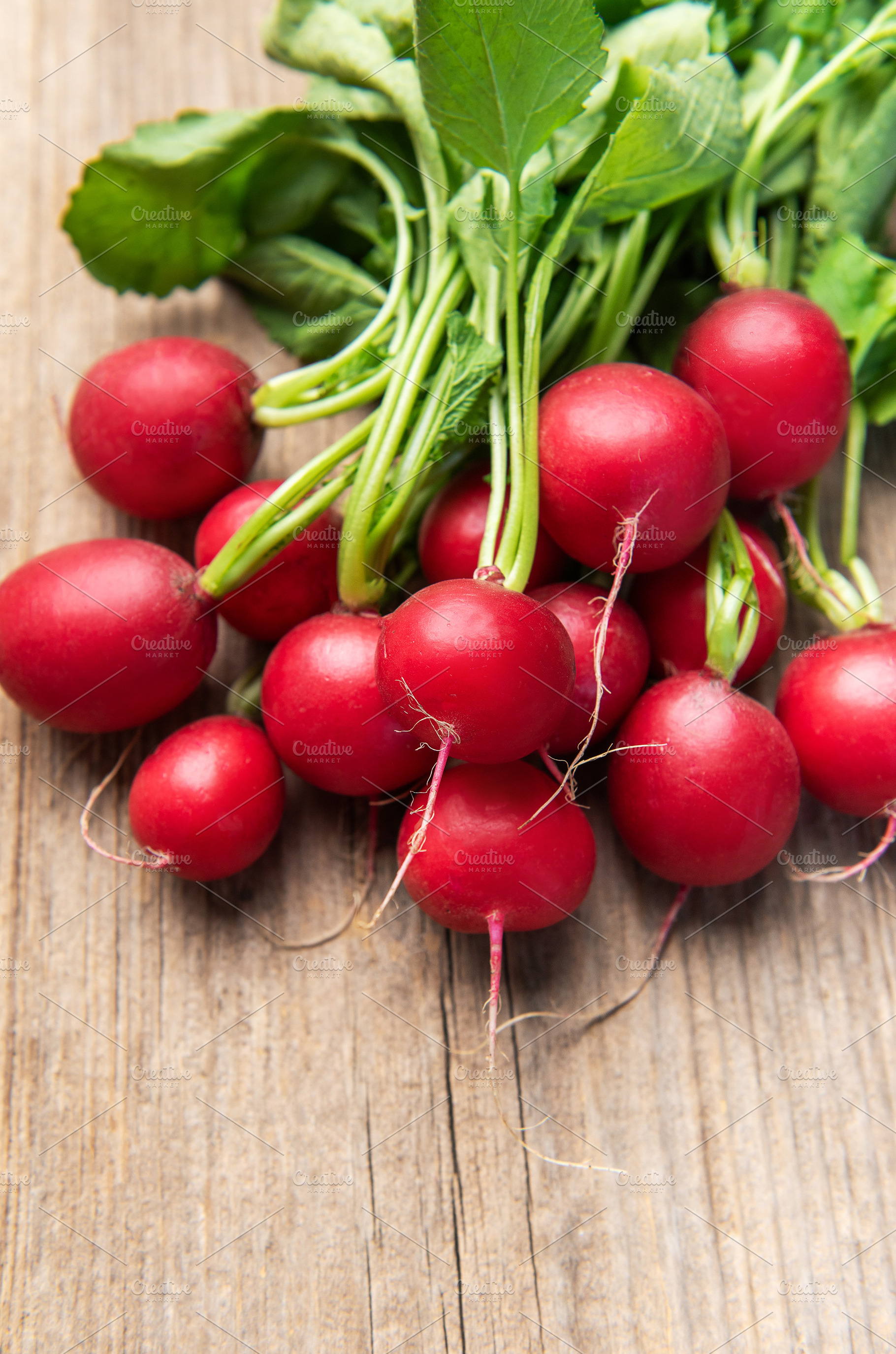 Fresh radishes bunch on rustic wooden table, a Food & Drink Photo by Olena Rudo