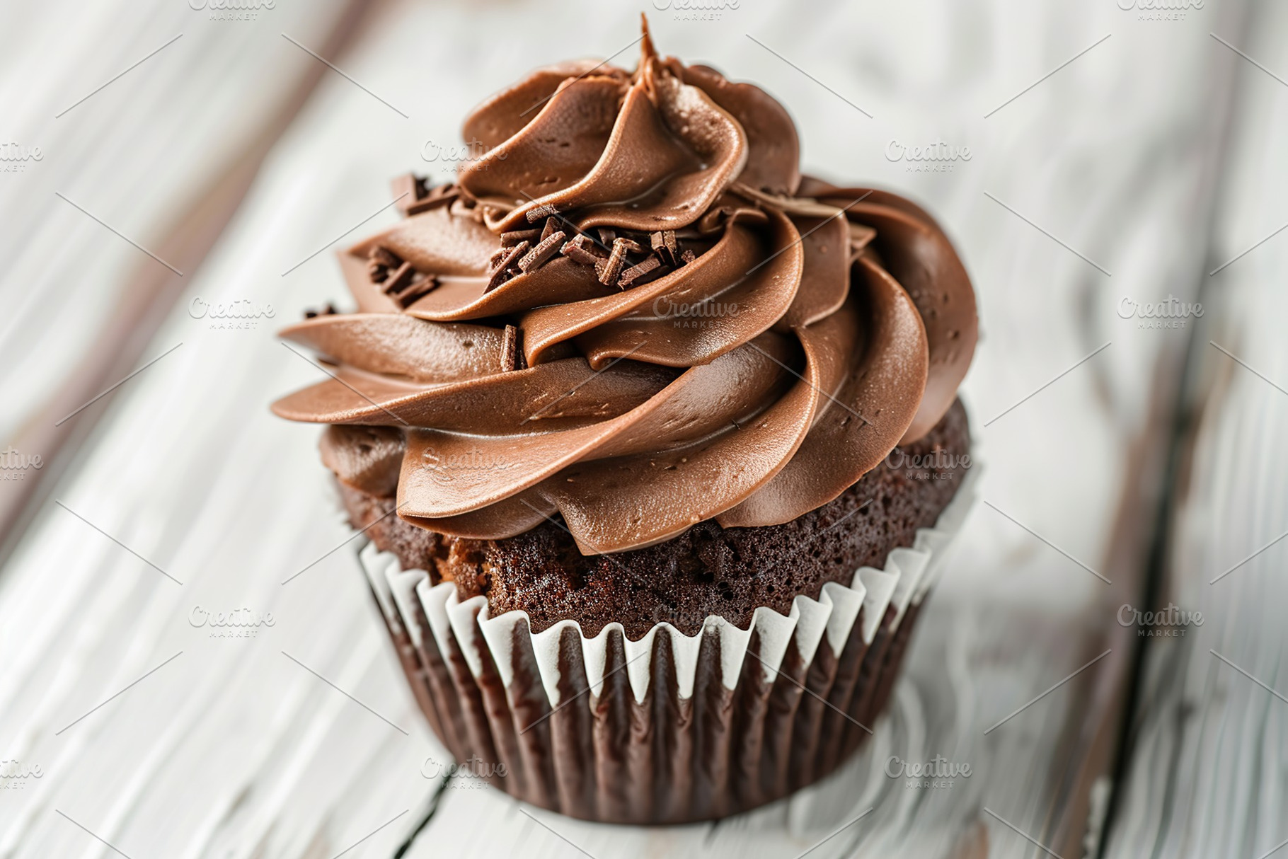 Chocolate cupcake with whipped cream on wooden table, a Food & Drink Photo by AlyaAnd