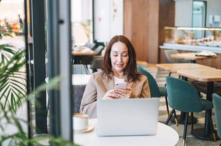 Adult woman using laptop in cafe, a Business Photo by Galina_Zhigalova