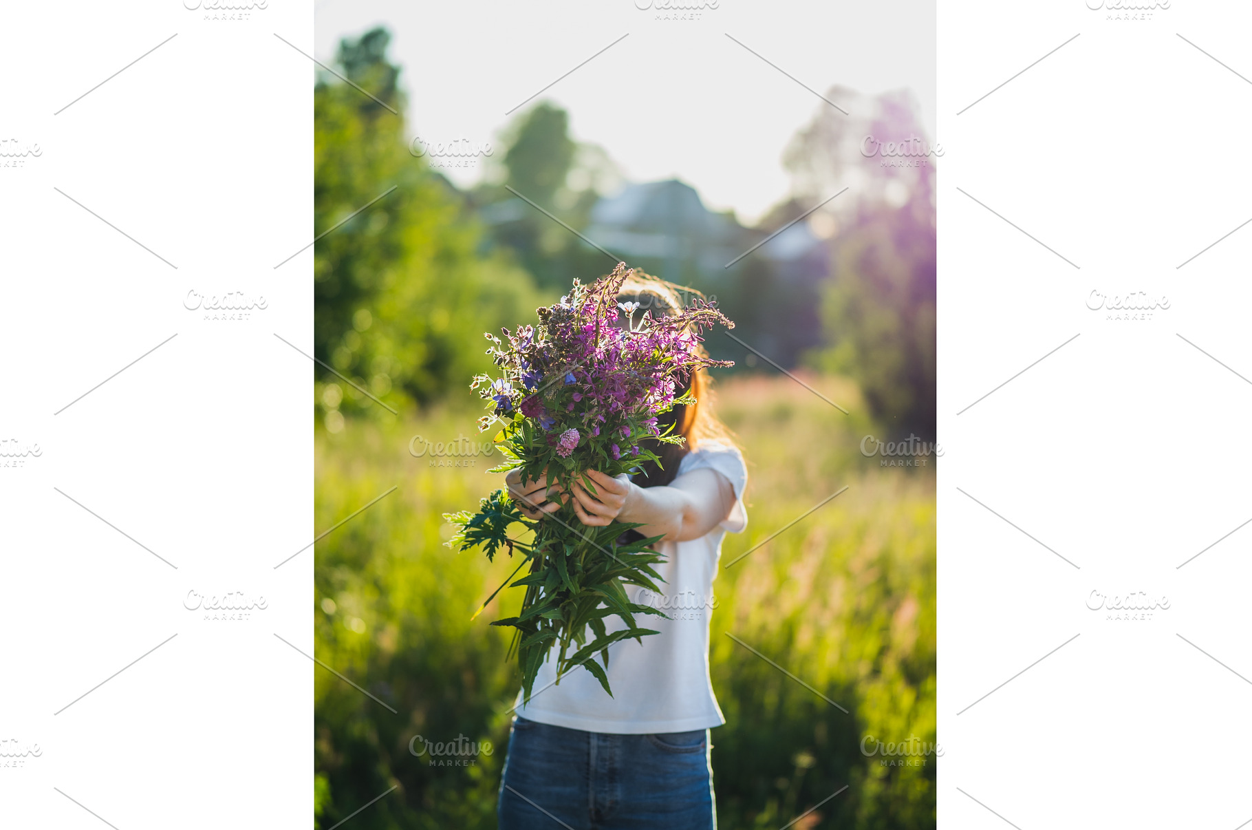 Young woman holds wild flowers, a Beauty & Fashion Photo by Fascinadora