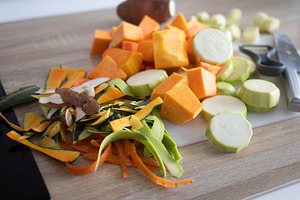 Top view of fresh vegetables being chopped on cutting board in home kitchen, a Food & Drink Photo by etorres69