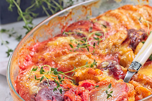Sweet potato, parsnips and beet root au gratin with thyme and melted cheese, in, a Food & Drink Photo by iuliia_n