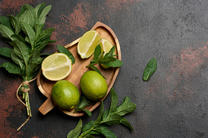 Bunch of fresh green mint and lime , top view, a Nature Photo by ndanko