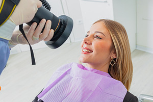 Dentist taking pictures of patient's teeth with professional camera in dental c, a Health & Medical Photo by Antonio Gravante Market