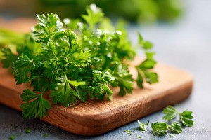 Fresh and ripe parsley on wooden board, a Food & Drink Photo by AlyaAnd